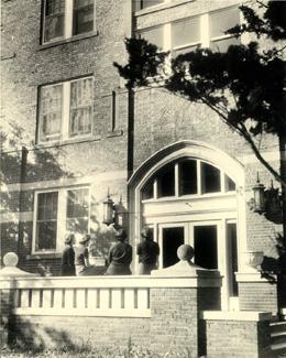 Built during the Teachers School years, the Women's Residence Hall was the only dormitory for women on campus.  Several women chat outside the front entrance of the residence hall several days prior to a tragedy that would result in the death of a student and eventually lead to the renaming of the hall to honor the student. 