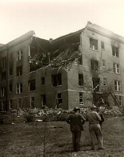 Officials survey the damage to the Women's Residence Hall after the blast.